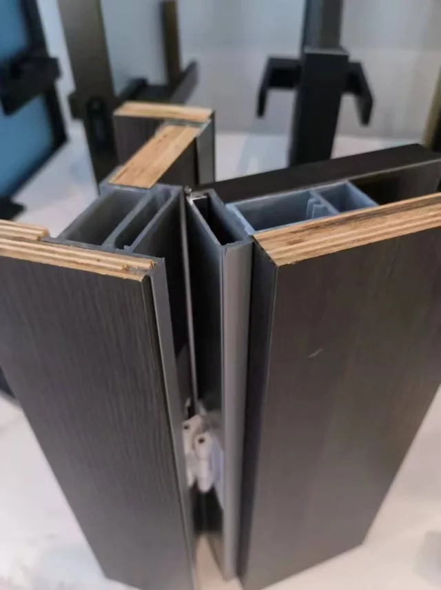 Close-up of decorative panels meeting aluminium edge and joint profiles