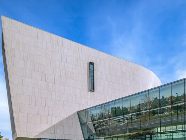 Large-format architectural wall cladding on a curved public building